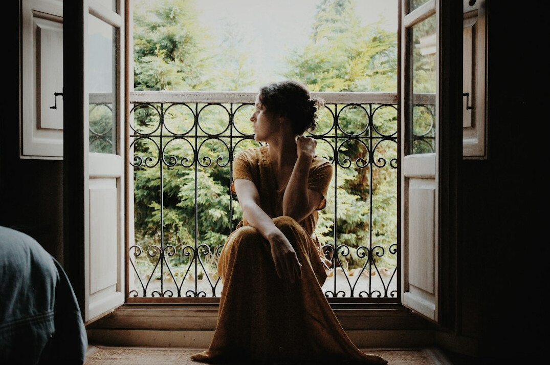 woman thinking at window